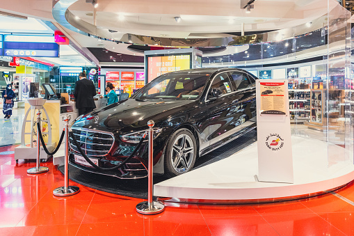 Dubai, UAE - April 27 2020: Image from Dubai Duty Free retail spare displaying luxury sedan for lucky draw winner. Dubai International Airport Terminal also have many other modern amenities such as restaurants, retail space, gaming arcades, prayer rooms, relaxation facilities such as spa and hotels which transiting passengers can take advantage of during their long haul flights.