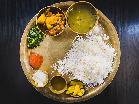 Nepali Food Served on a copper platter with variety of authentic staple delicacies