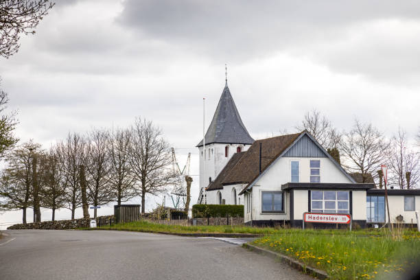Hjerndrup church with a detached house in front on the peninsular Jutland