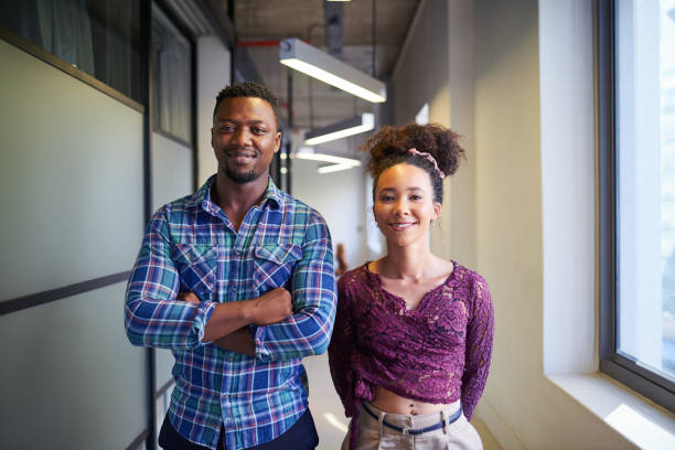 istock Two young founders pose in the office corridor side by side 1398260578