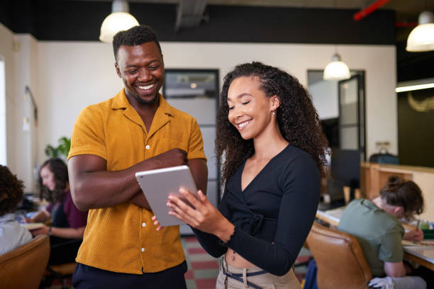 istock A young multi-ethnic woman shows her colleague a information on a digital tablet 1398260698