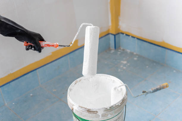 istock hand holding paint roller in home decoration work 1398261550