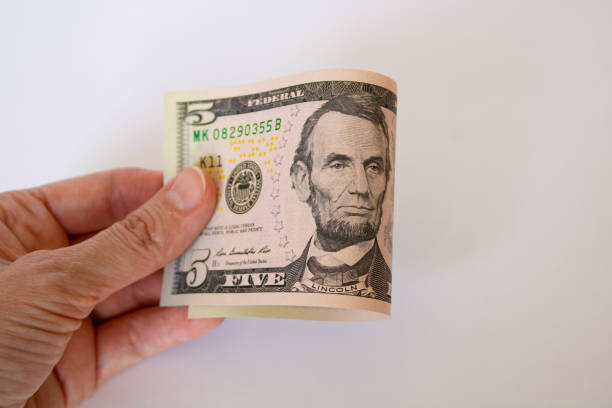 istock Banknote five american dollars in hand. keep money 1398261584