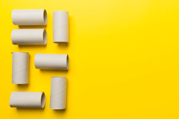 istock Flat lay composition with empty toilet paper rolls and space for text on color background. Recyclable paper tube with metal plug end made of kraft paper or cardboard 1398262061