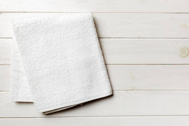 istock Top view of white towels with copy space on colored background 1398262066