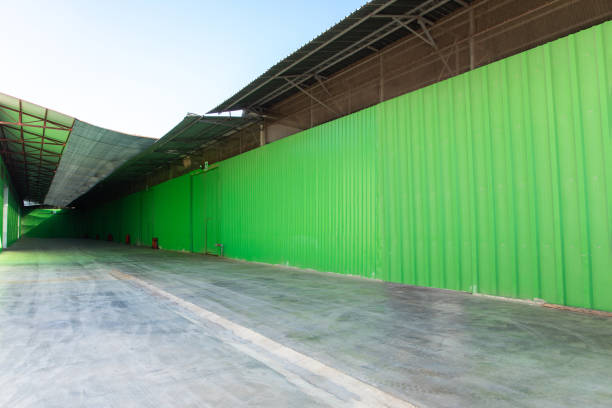 istock Industrial warehouse with corrugated iron or metal green galvanized wall. 1398265604