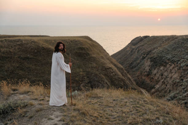 istock Jesus Christ on hills at sunset. Space for text 1398266712