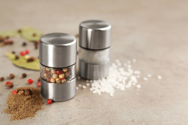 istock Salt and pepper shakers on light grey table, closeup. Space for text 1398266921