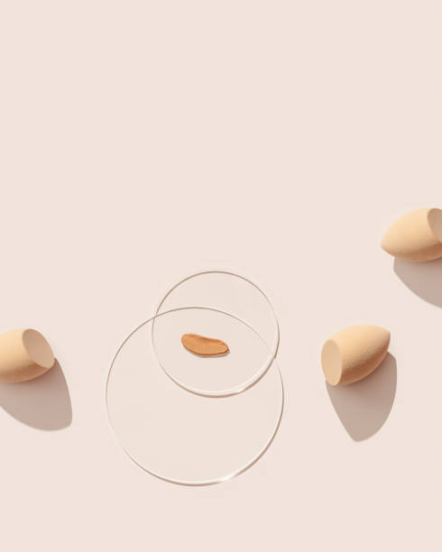 istock Makeup sponges for foundation cream, samples on glass disk on beige color background with shadows. Skincare beauty blender. Flat lay swatches from tone cream and sponge, aesthetic trends 1398267106