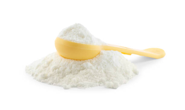 istock Powdered infant formula and measuring scoop on white background. Baby milk 1398268281