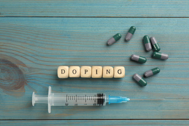 istock Cubes with word Doping and drugs on light blue wooden background, flat lay 1398268607