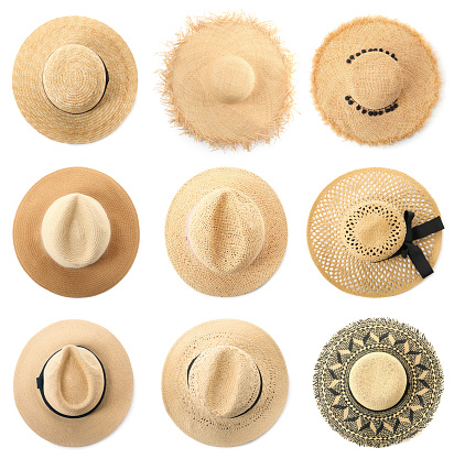 Set with different straw hats on white background, top view. Stylish headdress