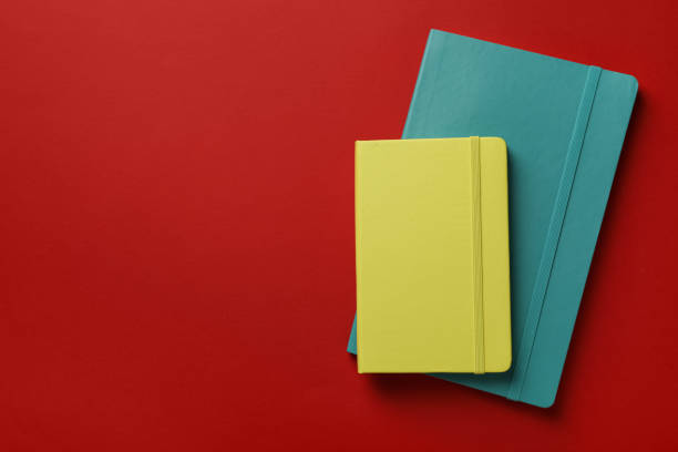 istock New stylish planners on red background, top view. Space for text 1398268744