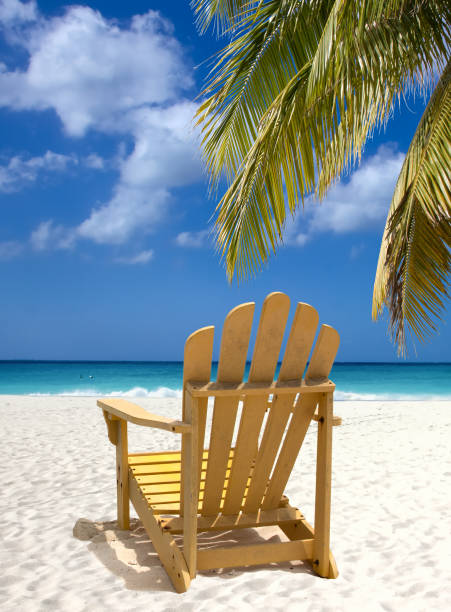 istock Yellow lounge chair on white sand beach 1398268856