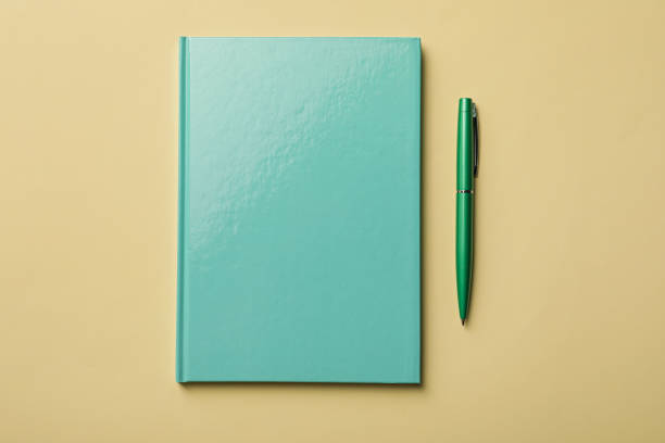 istock New turquoise planner and pen on beige background, flat lay 1398269537
