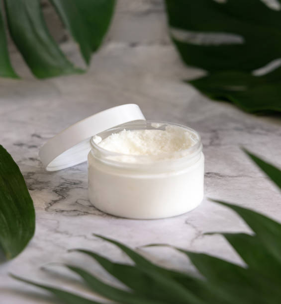 istock White jar and monstera leaves on marble table close up. Brand packaging mockup 1398269767
