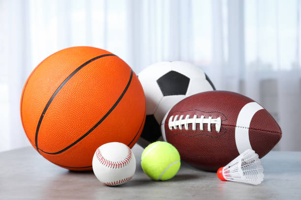 istock Set of different sport balls and shuttlecock on light grey table 1398269807