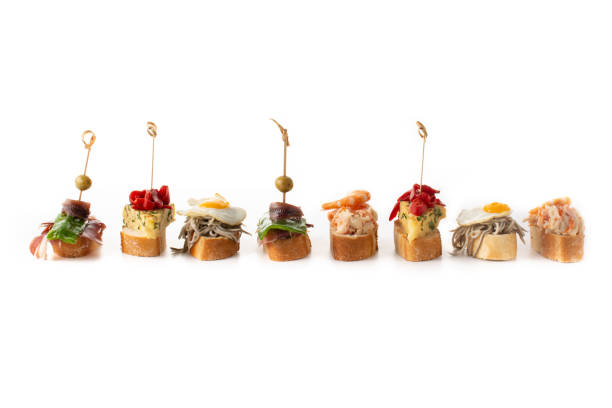 Assortment of Spanish pintxos Assortment of Spanish pintxos isolated on white background appetizer stock pictures, royalty-free photos & images