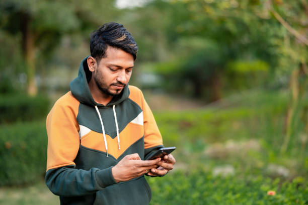 istock Busy man working outdoor and using mobile phone for sending text message. 1398272443