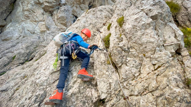 istock Boy hiker climbing on mountain 1398277349