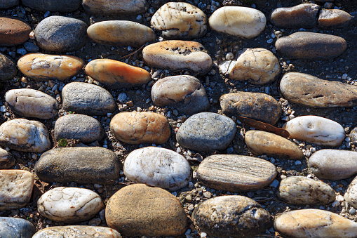 Pebbles ornate on the ground . Decorative stones background