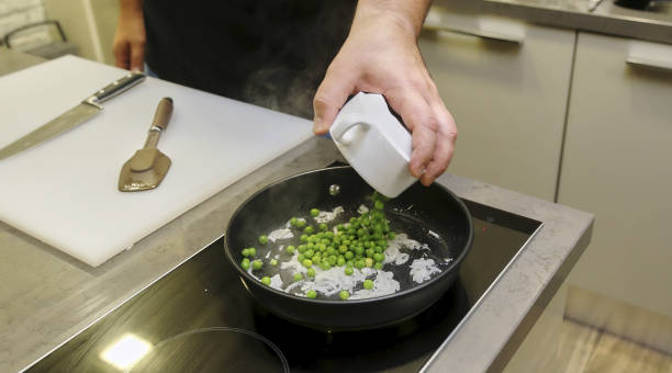 pois verts dans la cuisine dans une casserole. - pea pod photos et images de collection