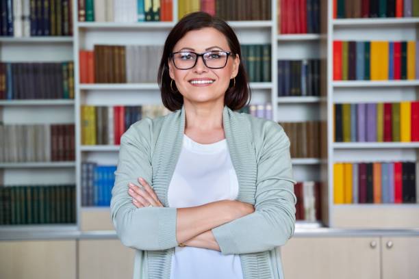 Portrait of middle aged smiling business woman looking at camera stock photo