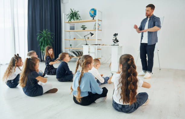 istock Learning gesture language. Group of children students in class at school with teacher 1398282998