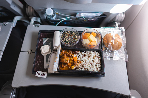 High angle view of plate with Non Lactose Meal food, at the airplane