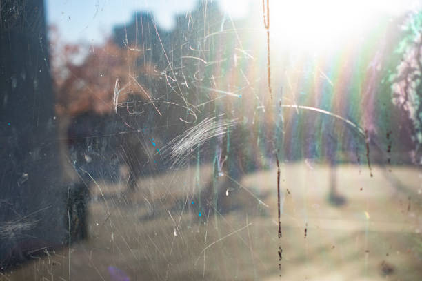 Scratched mirror. Damaged surface of glass. Dirt in display case. Window details. stock photo