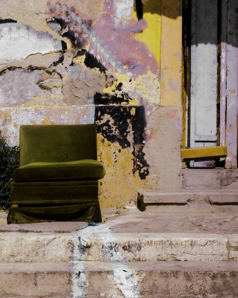 istock Green chair outside abandoned building. 1398287371