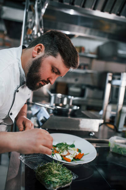 istock Two brothers is making salad. Professional chef preparing food in the kitchen 1398287596