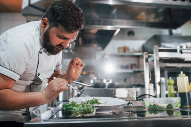 istock Some additional ingredients. Professional chef preparing food in the kitchen 1398287609