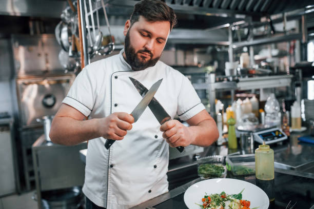 istock With sharp knives. Professional chef preparing food in the kitchen 1398287624