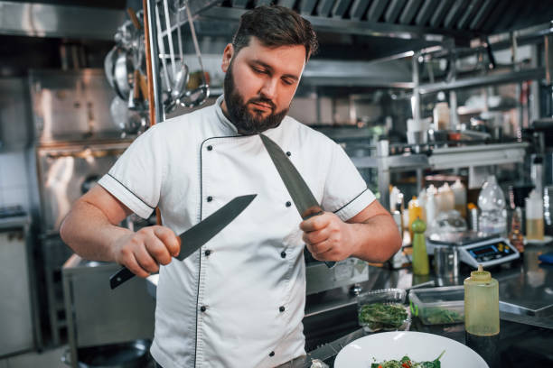 istock With sharp knives. Professional chef preparing food in the kitchen 1398287634