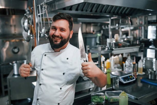 istock With sharp knives. Professional chef preparing food in the kitchen 1398287644
