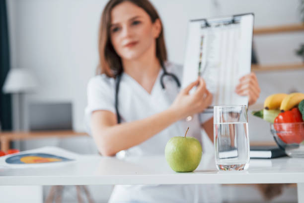 istock With document in hands. Professional medical worker in white coat is in the office 1398288552