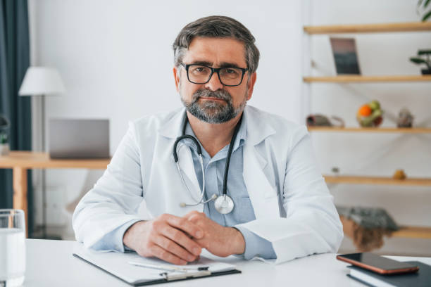 istock Professional medical worker in white coat is in the office 1398288730