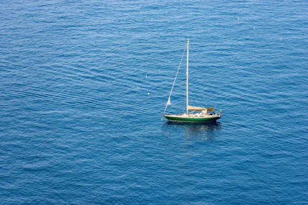 Photo of Green Sailing Boat Moored in the Blue Sea - Cinque Terre Liguria Italy