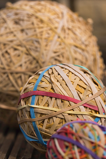 Large balls of elastic bands, collected over many years and beginning to perish. Their owner wears an anorak and train-spotting is his other hobby.