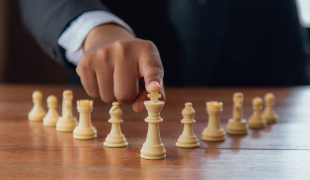 istock Leadership and teamwork strategy concept, business people shaking hands on wooden table. Planning strategy with chess numbers 1398291728