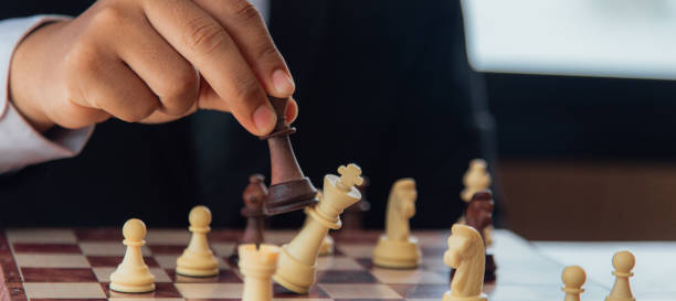 istock Leadership and teamwork strategy concept, business people shaking hands on wooden table. Planning strategy with chess numbers 1398291730