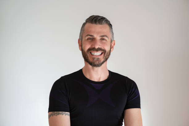 istock Portrait of smiling handsome man looking at camera over white background 1398293085