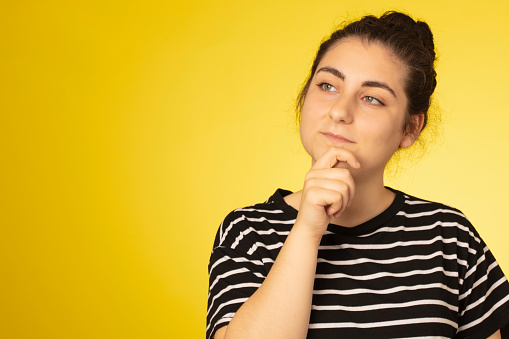 Photo portrait of  creative idea wear girl wearing striped t-shirt isolated on yellow background