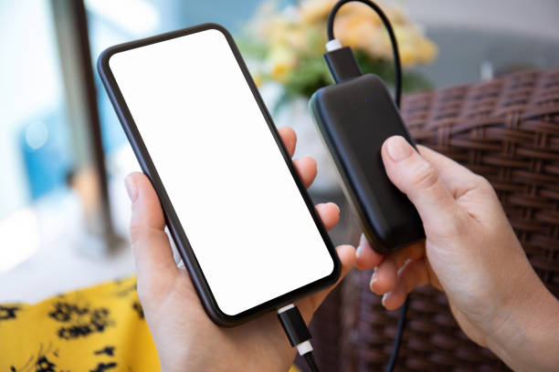 istock female hands holding phone with isolated screen connected to powerbank 1398296830