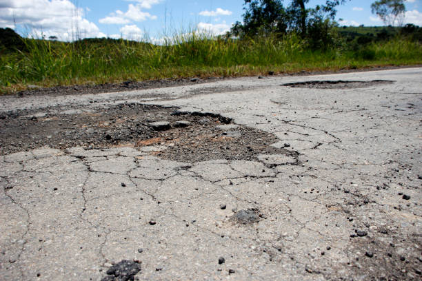istock highway with damaged asphalt unsuitable for driving 1398298621