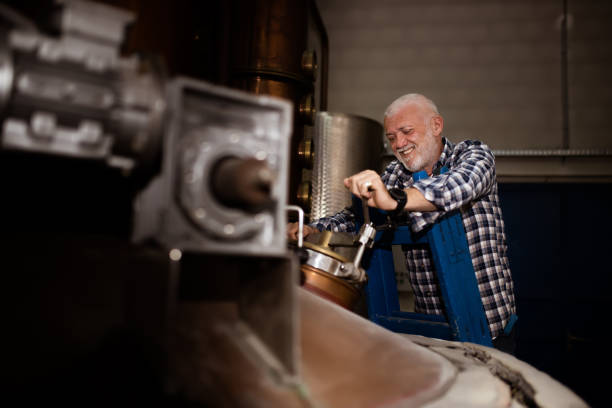 istock Male worker operating machinery in distillery 1398299402