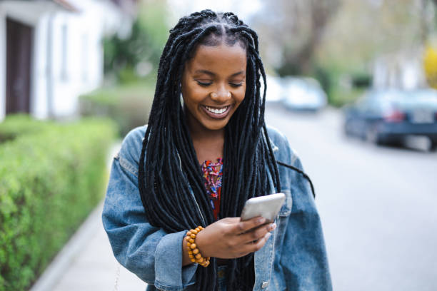 Young woman using her smartphone in the city stock photo