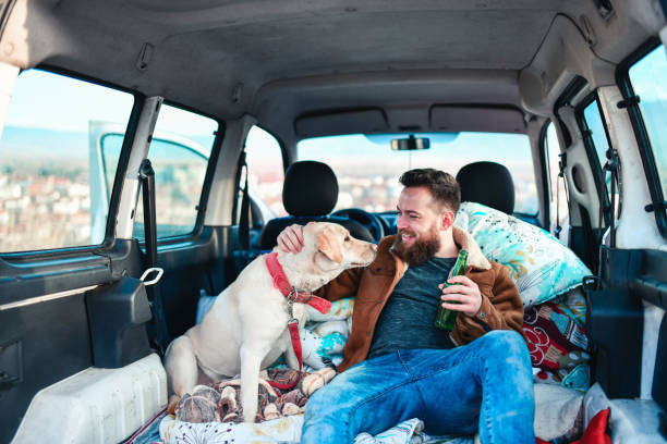 istock Beer Time For Smiling Male And Dog In Minivan Trunk 1398299567