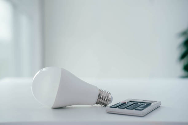 istock Energy saving concept. Calculator with light bulb . Save electricity. 1398299585
